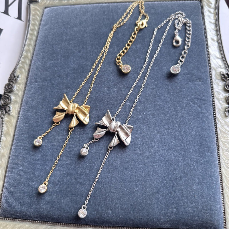 Bow crystal tassel necklace pair, gold-tone and silver-tone with round crystal drops