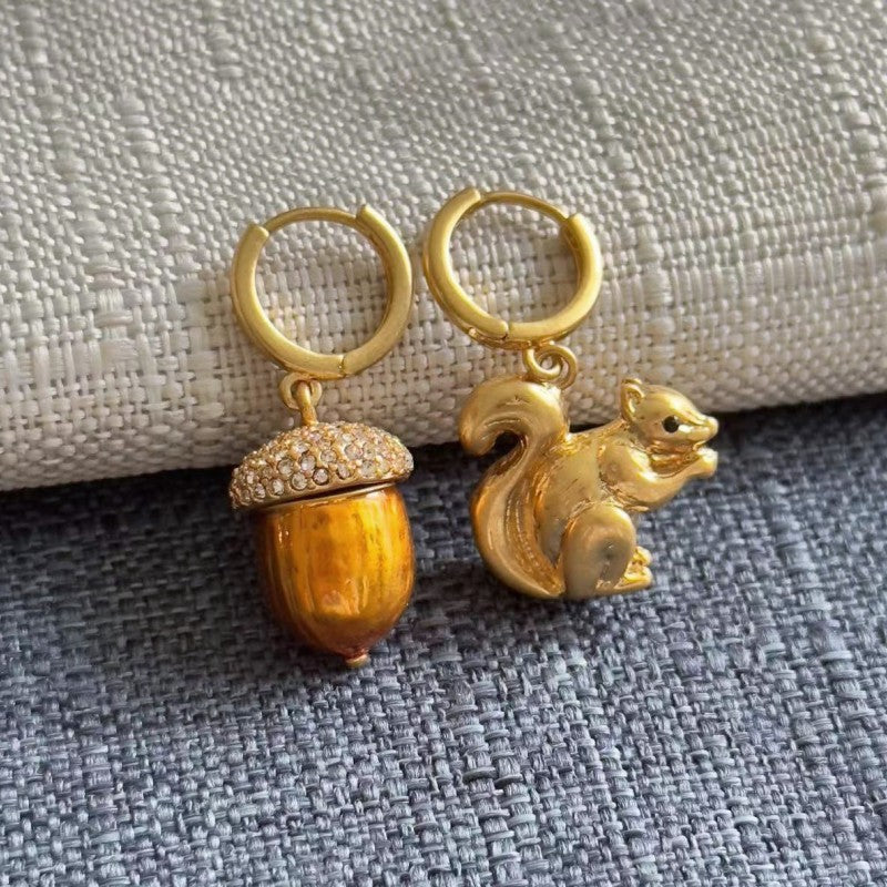 Gold-tone hoop earrings with squirrel and acorn charms, crystal-studded tops