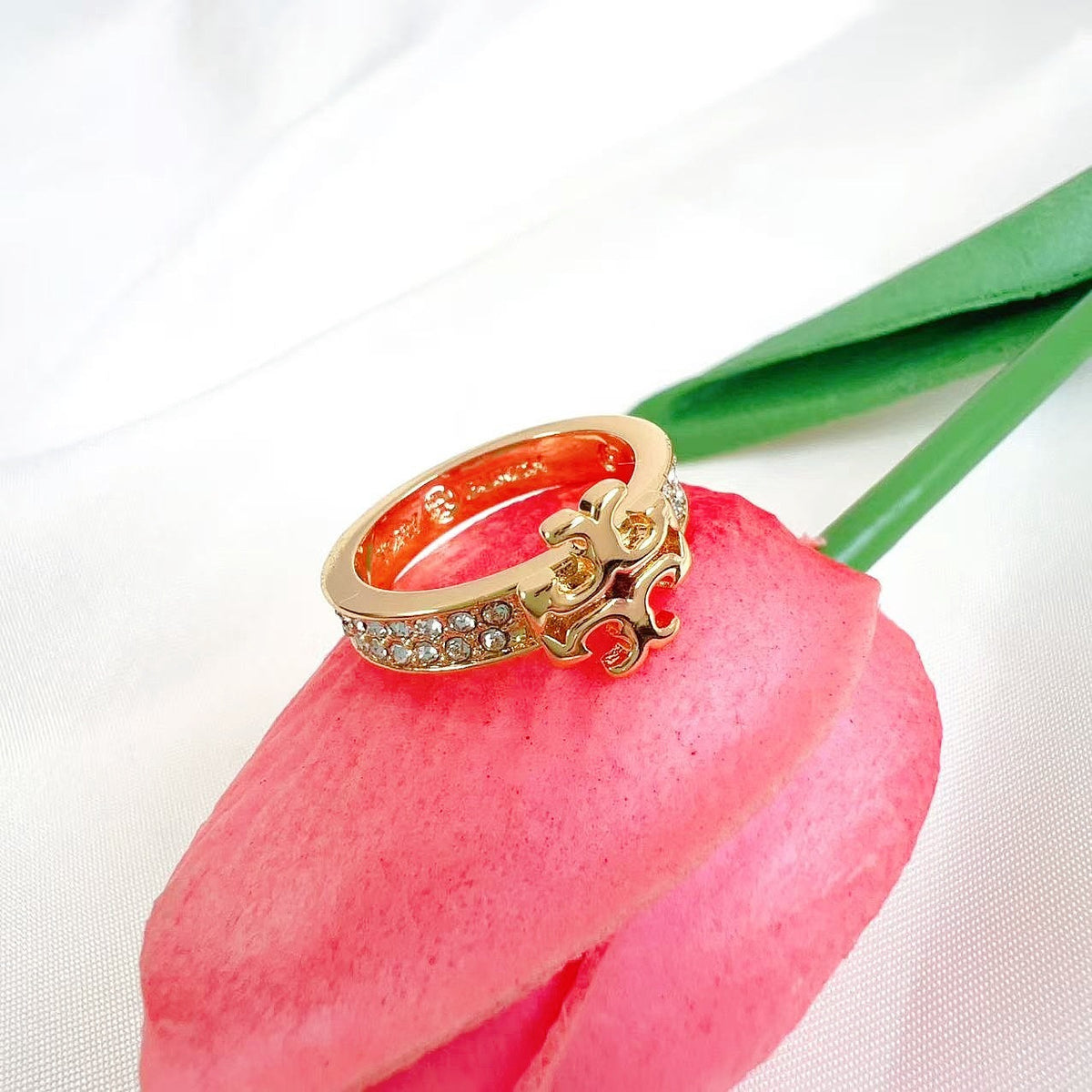 Gold diamond logo ring with red enamel crest and pavé stone band