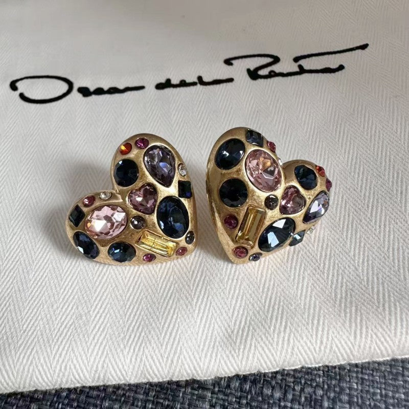 Heart crystal stud earrings in gold tone with dark blue stones and light pink crystal centers