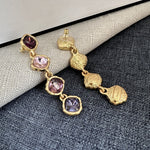 Full-crystal square drop earrings with purple and lilac stones on gold-tone links
