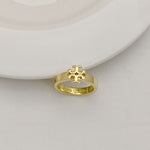 Gold-tone geometric letter-style ring with raised lattice emblem on top