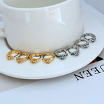 Geometric enamel hoop earrings set: gold-tone and silver-tone with green accents