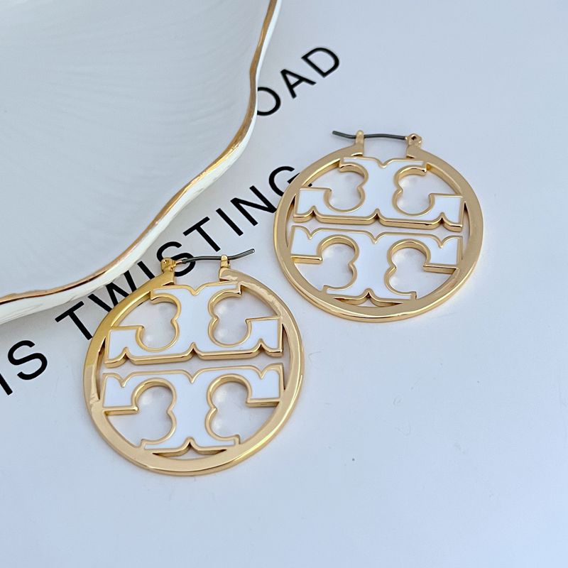Gold-tone round enamel logo earrings with white cutout quatrefoil pattern