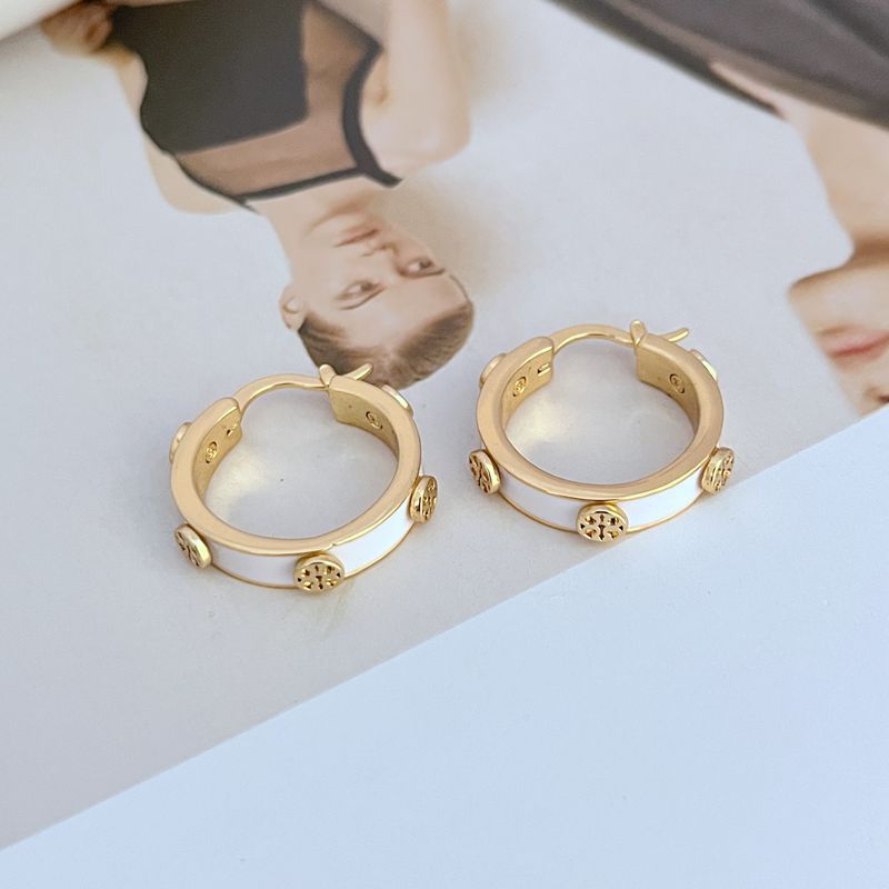 Tory Burch enamel logo hoop earrings, gold-tone with white enamel and ridged detailing