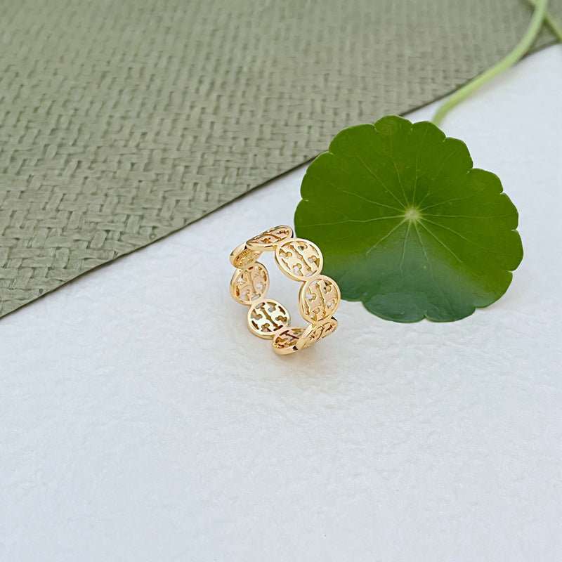 Gold-tone patchwork circular logo ring, textured link detail