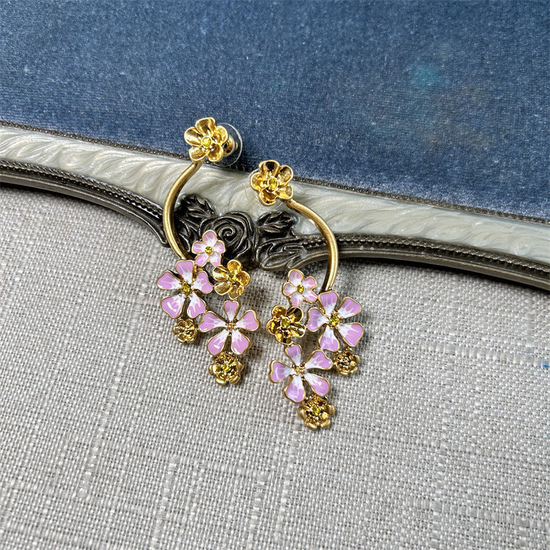 Long enamel flower hoop drop stud earrings with pink petals and gold details