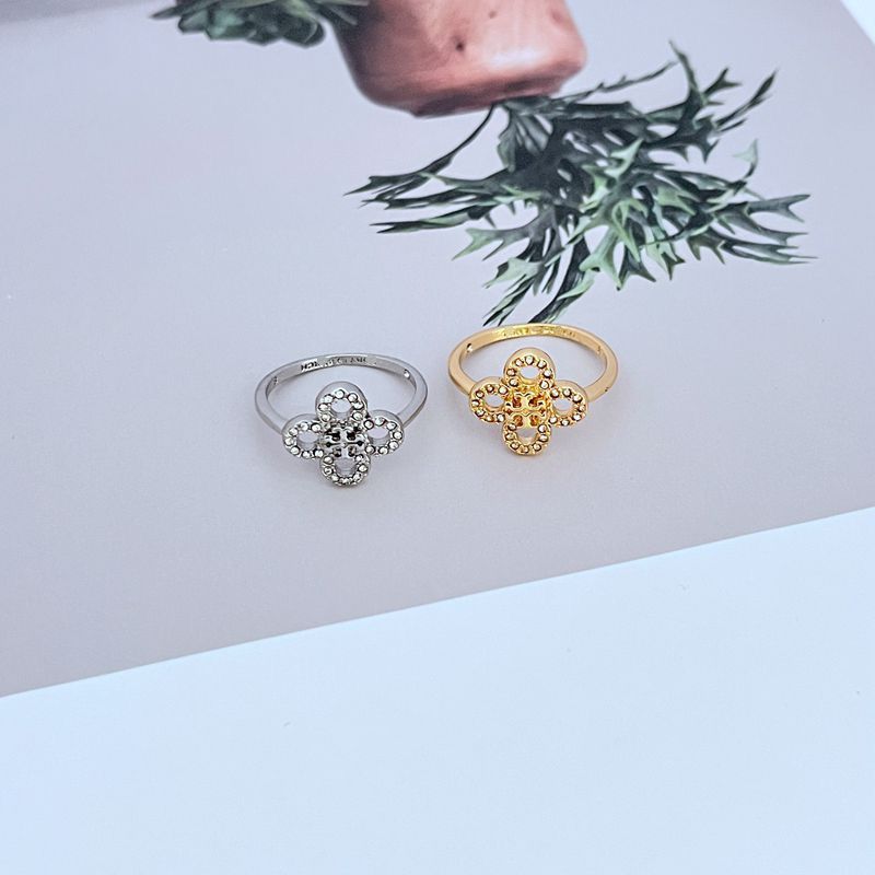 Two rings: white gold and gold four-leaf clover flower metal rings with diamond accents