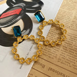 Large round floral zircon earrings with blue stones and goldtone clover-style flower ring