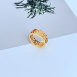 Gold metal logo ring with openwork cutout design, wide band