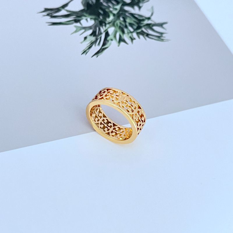 Gold metal logo ring with openwork cutout design, wide band