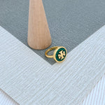 Round enamel metal ring with green shell center and gold-tone bezel