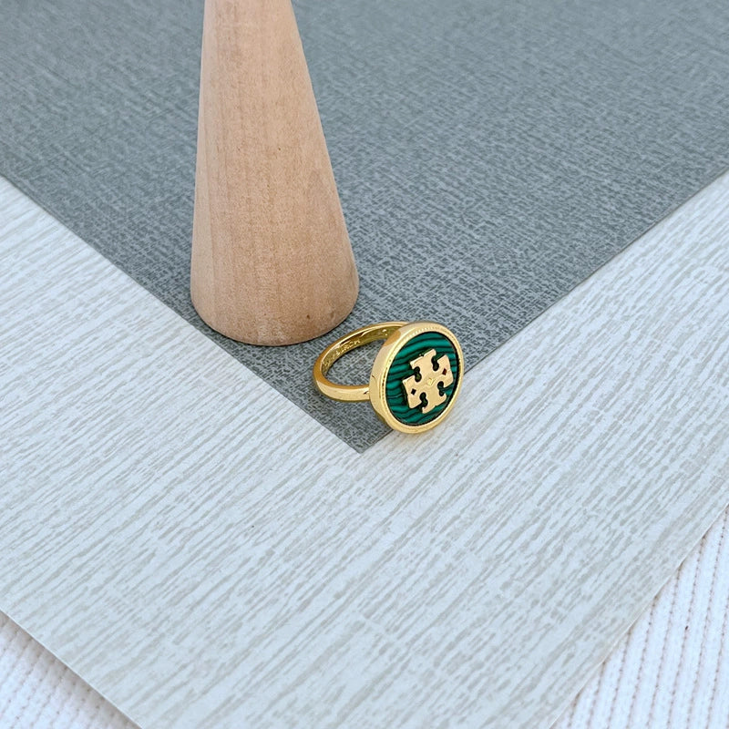 Round enamel metal ring with green shell center and gold-tone bezel