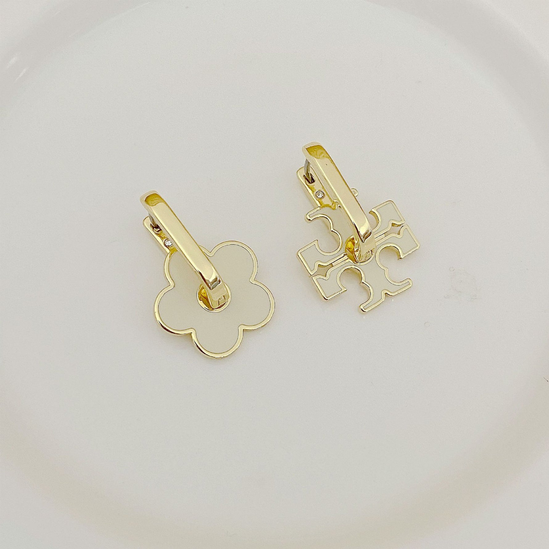 Tory Burch gold-tone logo U-shaped metal earrings with floral and puzzle cutouts