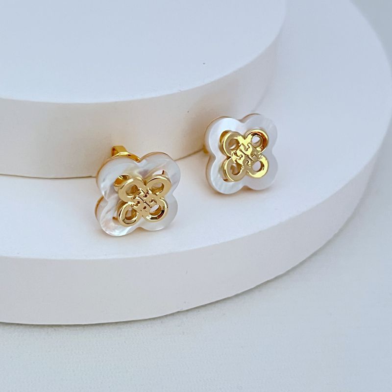 Openwork clover flower stud earrings with white enamel and gold-tone backs