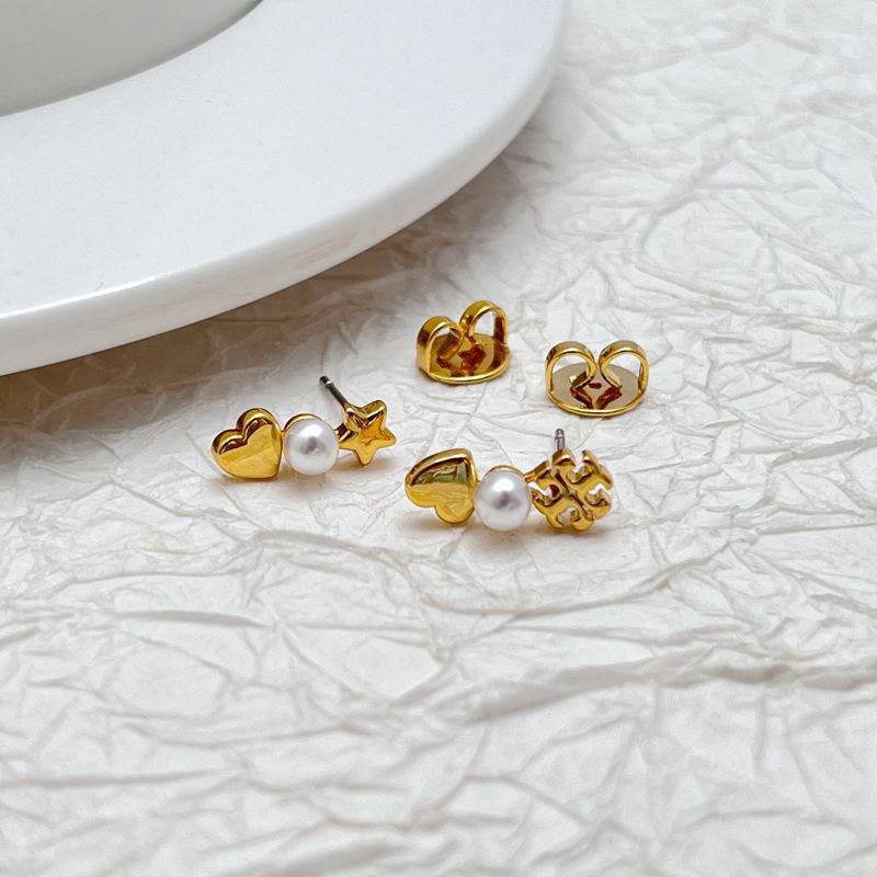 Pair of gold-tone earrings: pearl heart, star dangle, and small bead detail
