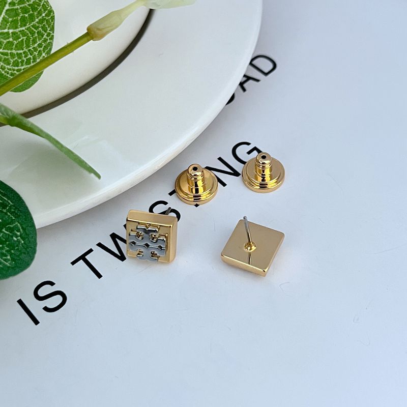 Gold square logo stud earrings with butterfly backs visible, geometric front