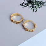 Gold round logo hoop earrings with crystal pavé and leopard-style insets