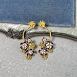 Long enamel flower hoop drop stud earrings with purple petals and gold accents