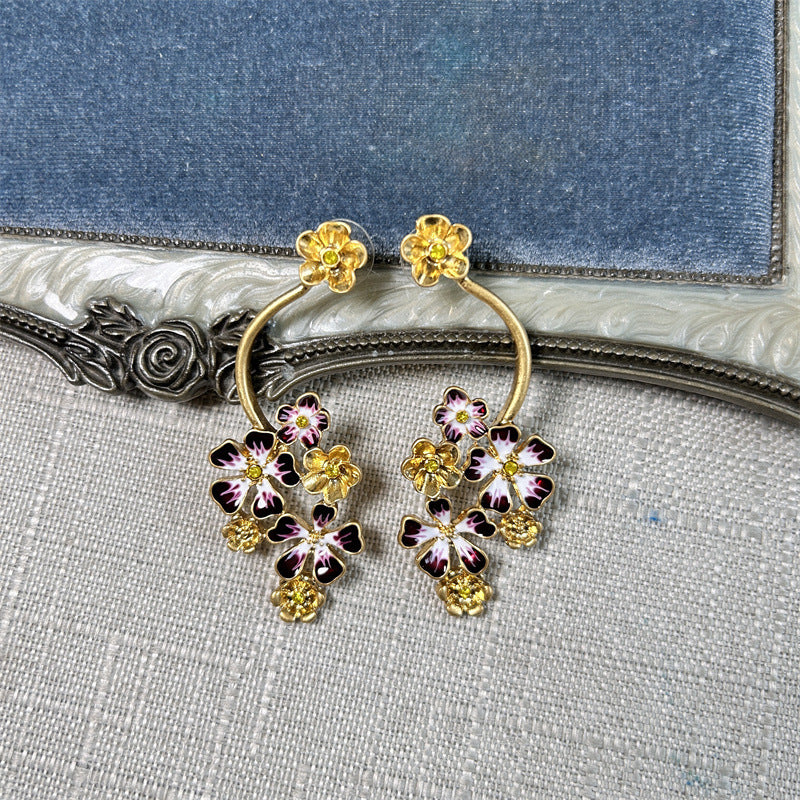 Long enamel flower hoop drop stud earrings with purple petals and gold accents