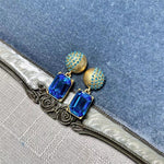 Earrings with blue rectangular stones and gold stud caps, square pendant dangle