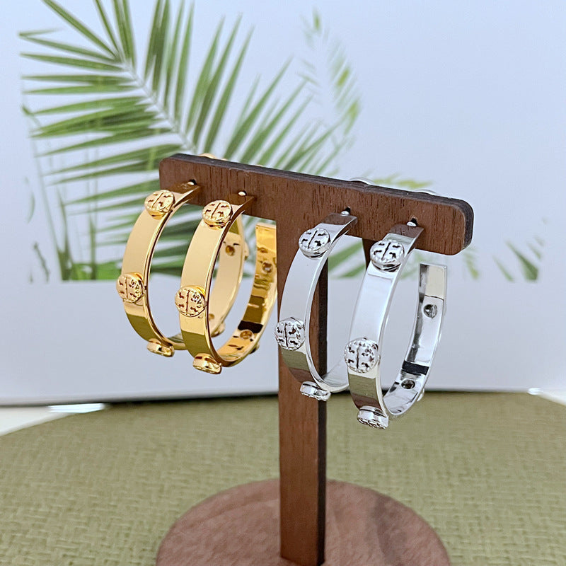 Tory Burch exquisite raised logo metal earrings