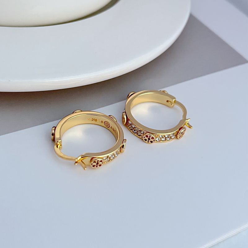 Gold hoop earrings with logo engraving and crystal pavé border