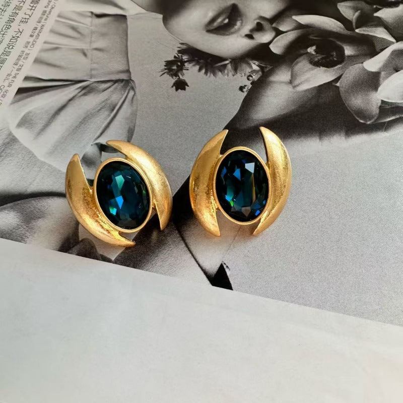 Oval Sparkling Crystal Earrings: dark blue oval crystals in gold crescent frames