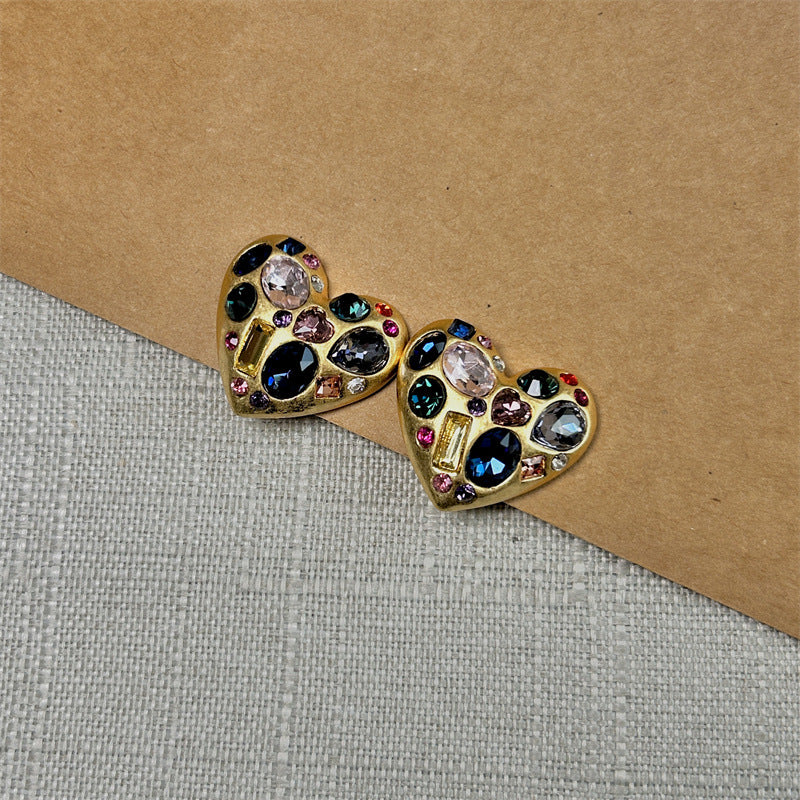 Gold-tone heart stud earrings with multicolor crystal stones, small pink and blue accents
