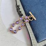 Purple crystal heart link bracelet with gold-tone chain and heart-shaped stones