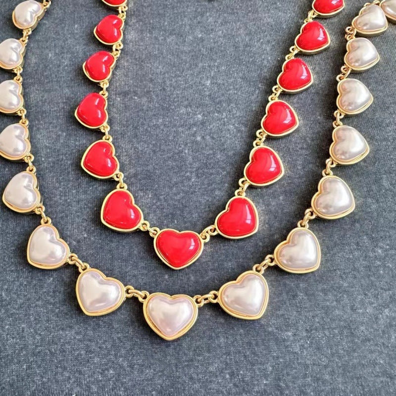 Heart-shaped necklace with gold chain, red and pearl white enamel heart charms