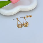 Gold hoop drop earrings with back studs and round charms featuring rhinestone pavé