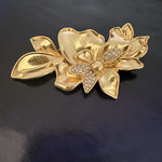 Gold-tone enamel jasmine flower brooch with rhinestone leaf accents