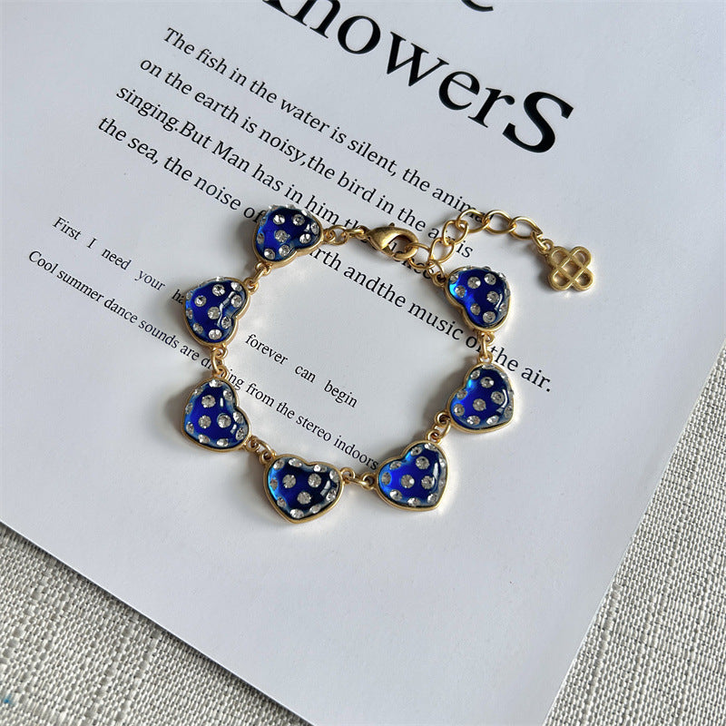 Blue matte heart bracelet, gold-tone chain with heart charms