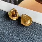 Tea-colored crystal heart stud clip-on earrings, showing gold back closure