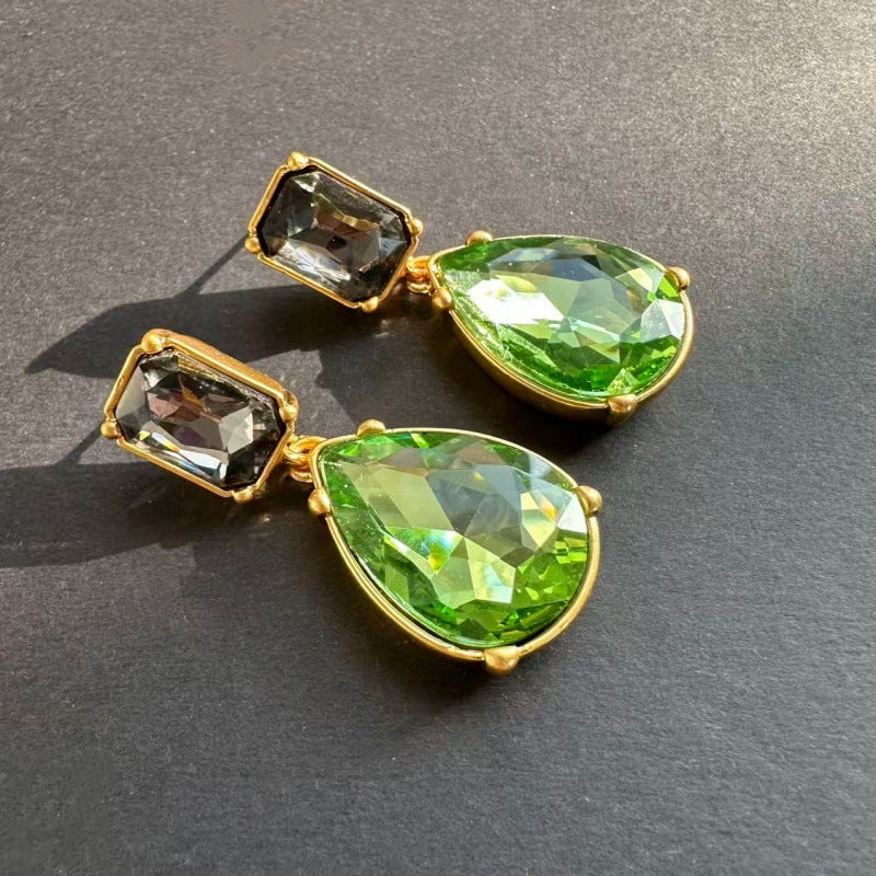Teardrop-cut crystal stud earrings with green teardrop drops and greenish square tops, gold tone