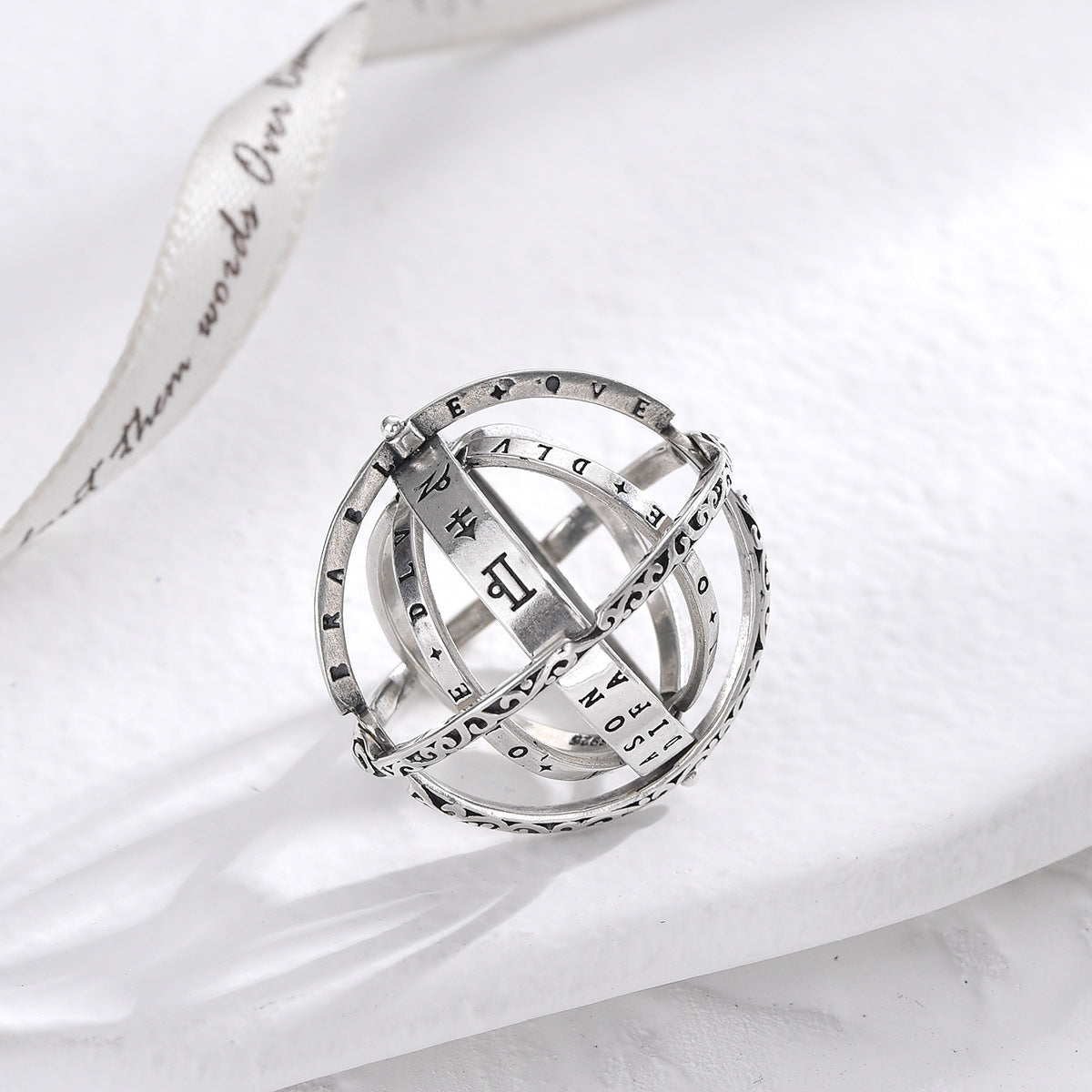 Silver transformable magic ring with celestial engraved sphere and star motifs