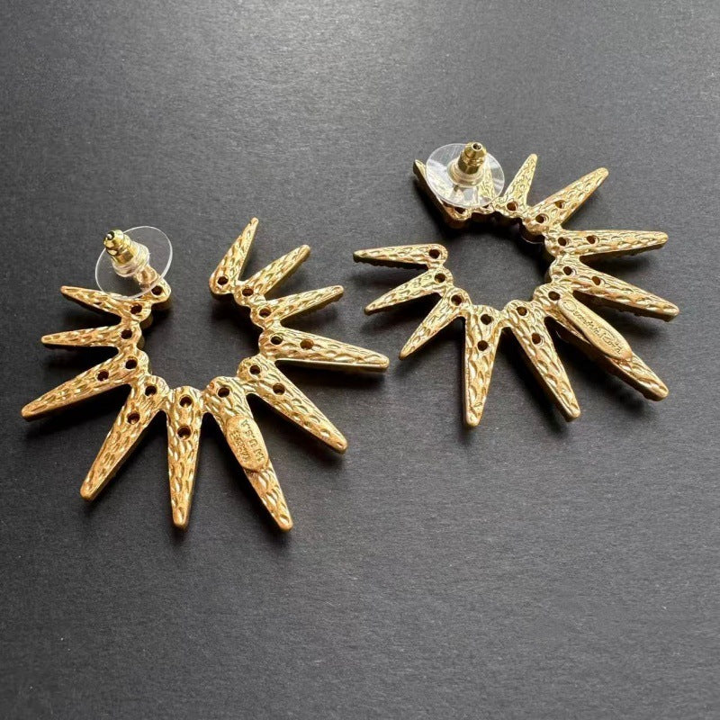 Gold White diamond starburst sunflower earrings with ornate starburst details