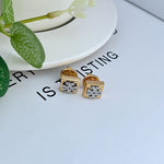 Gold square logo metal stud earrings, front view with geometric cutout