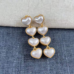 Smooth heart-shaped long drop earrings, white pearl hearts with gold-tone links