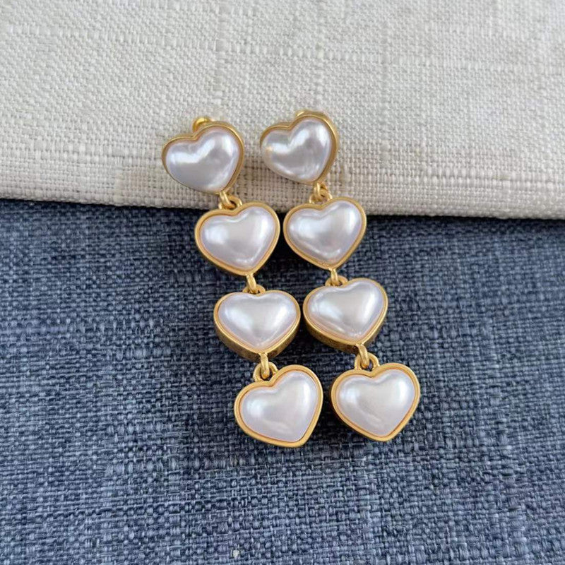 Smooth heart-shaped long drop earrings, white pearl hearts with gold-tone links