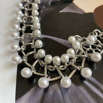 Silver pearl-link bracelet with large round pearls on intertwined chain
