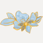 Blue and gold enamel jasmine-style flower brooch with crystal-like center