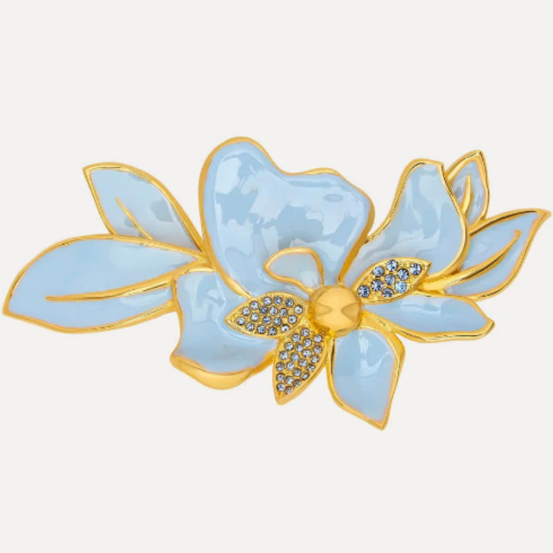 Blue and gold enamel jasmine-style flower brooch with crystal-like center