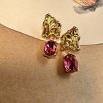 Rose-red crystal drop earrings with gold-tone textured caps