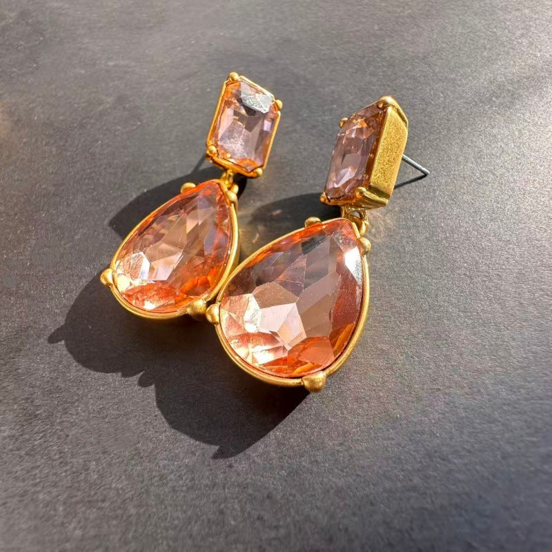 Teardrop-cut diamond stud earrings with champagne-peach stones in gold-tone, post backs
