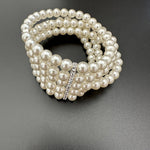 Multi-row pearl rhinestone stretch bracelet, silver-toned rhinestone strip center
