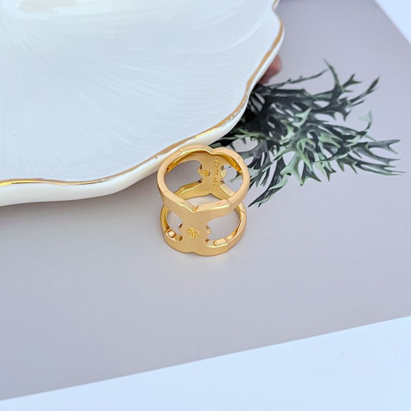 Gold-tone wide polished metal ring with cutout logo motif