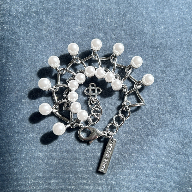 Silver-tone link bracelet with white faux pearl drops and chain fringe