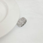 Silver-tone rhinestone letter inlay ring with engraved pattern and raised top